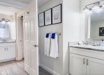 Featuring a double vanity and privacy door, this jack-n-jill bathroom feels more like two